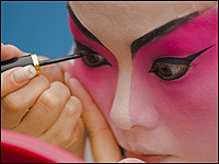 An opera star applies makeup in Hong Kong.