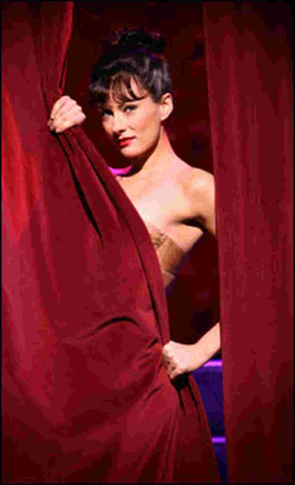 Laura Benanti peeks from behind a curtain