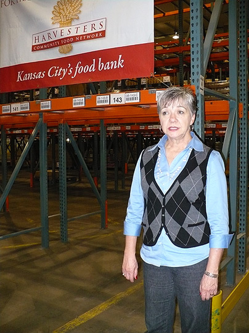 CEO Karen Haren stands in an empty warehouse run by Harvesters, a community food network.
