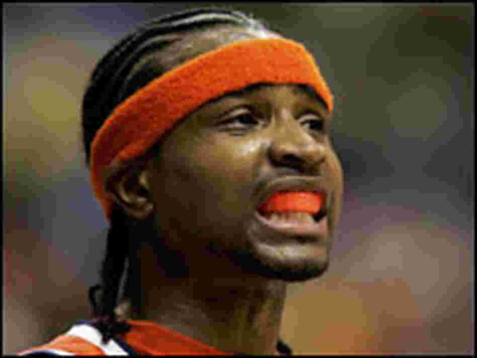 Dee Brown of Illinois shows off his orange mouthgard.
