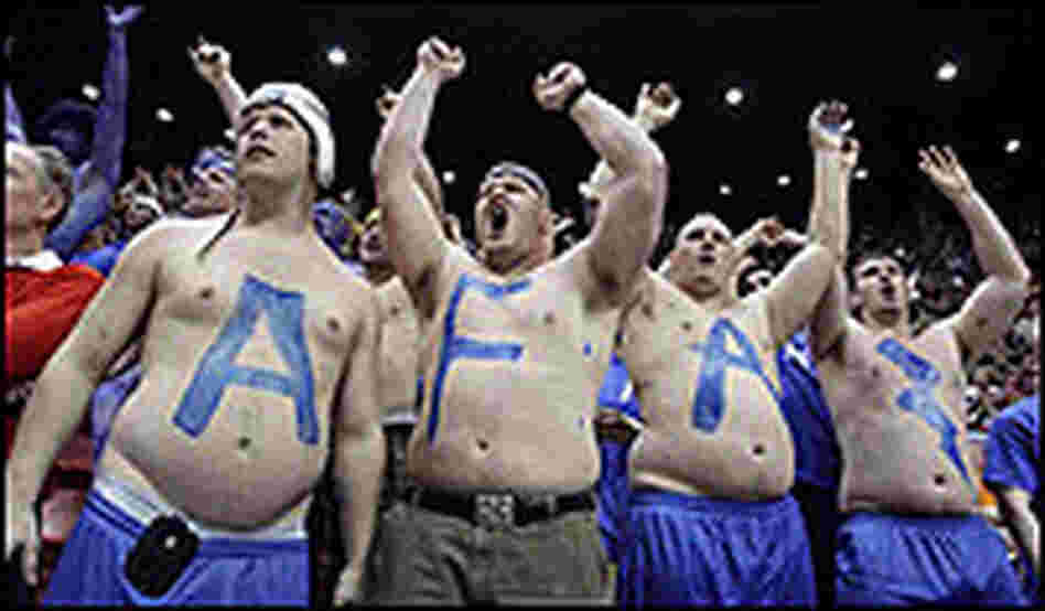 Bare-chested, big-bellied Air Force fans spell out AFA with a lightning bolt.