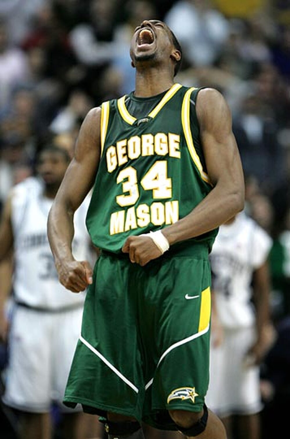 Will Thomas of George Mason exults after scoring a basket.