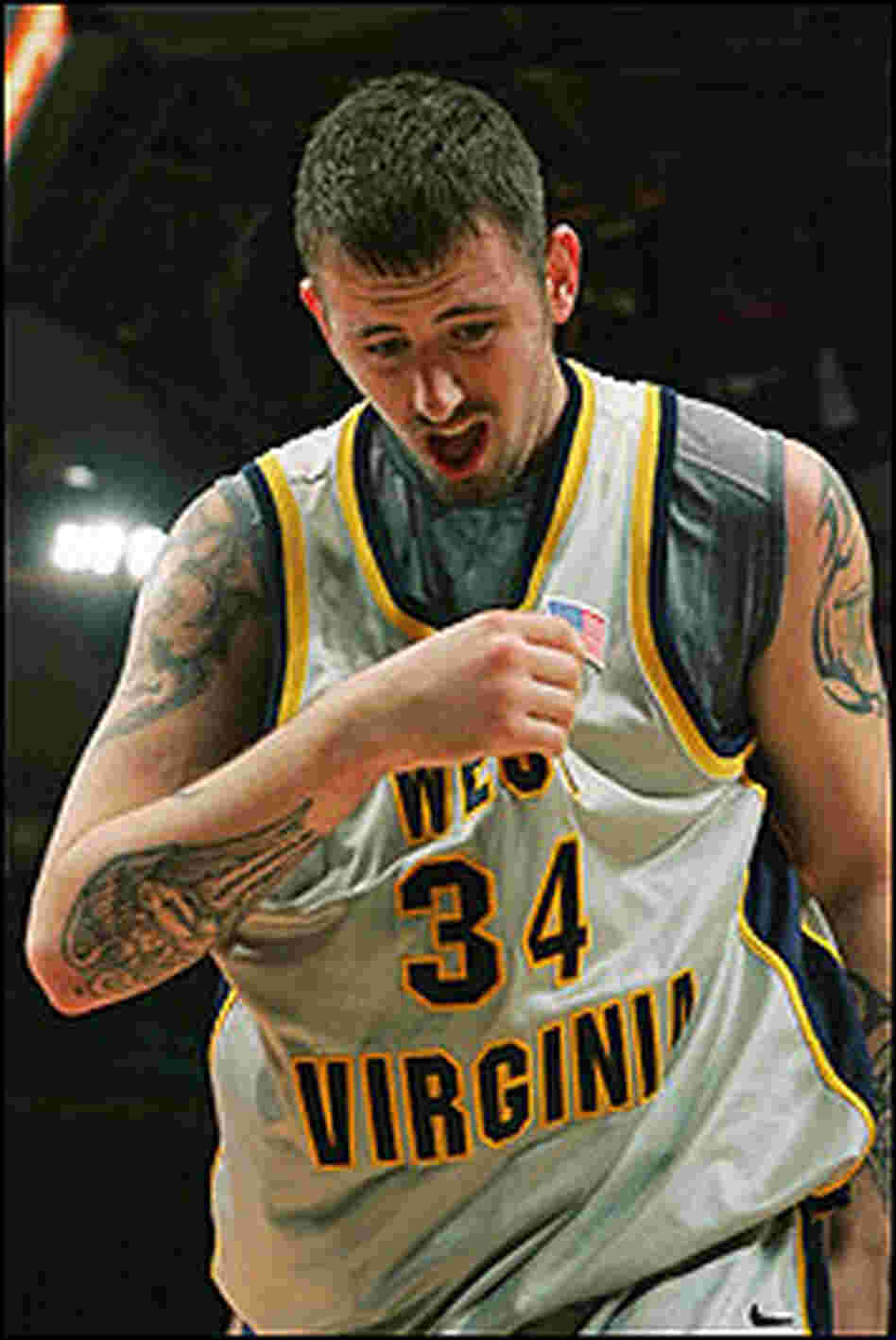 Kevin Pittsnogle of West Virginia shows off his tattoos.