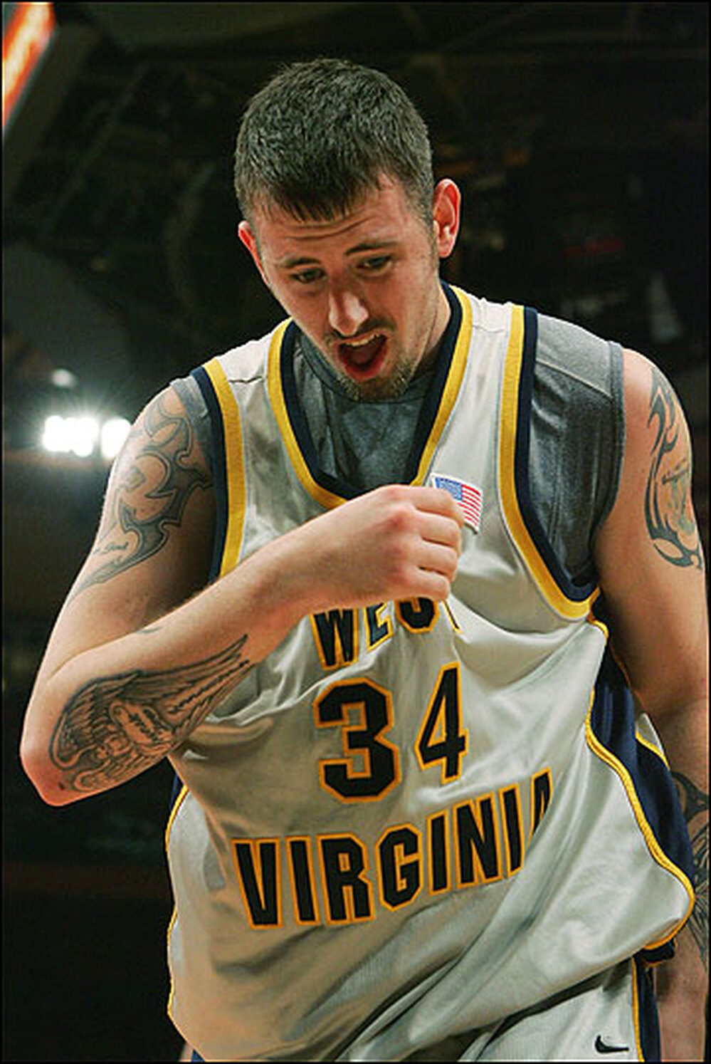Kevin Pittsnogle of West Virginia shows off his tattoos.