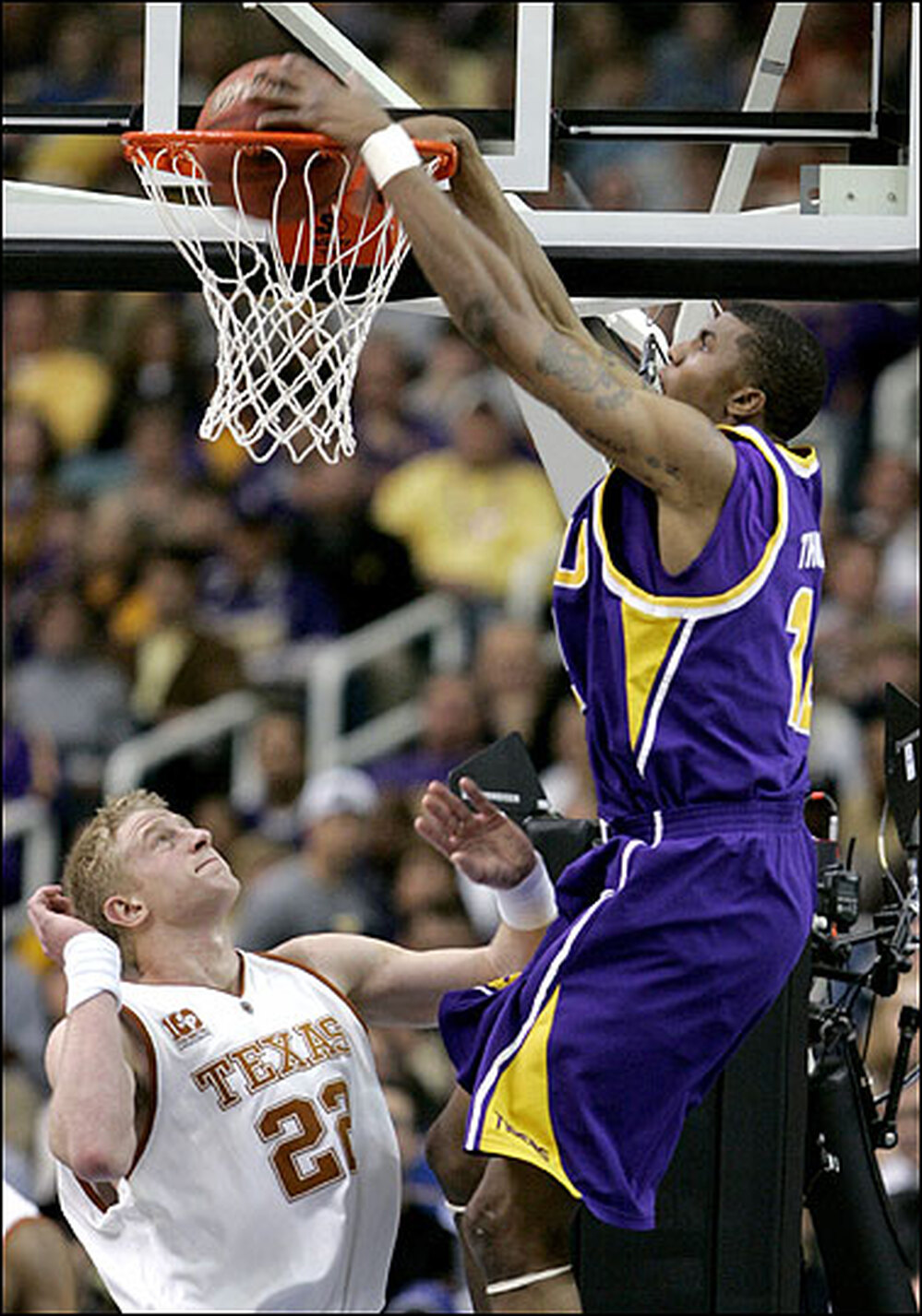 Tyrus Thomas of LSU dunks over Brad Buckman of Texas.