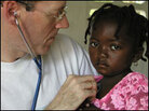Dr. Paul Farmer with a young patient. Dr. Paul Farmer with a young patient.