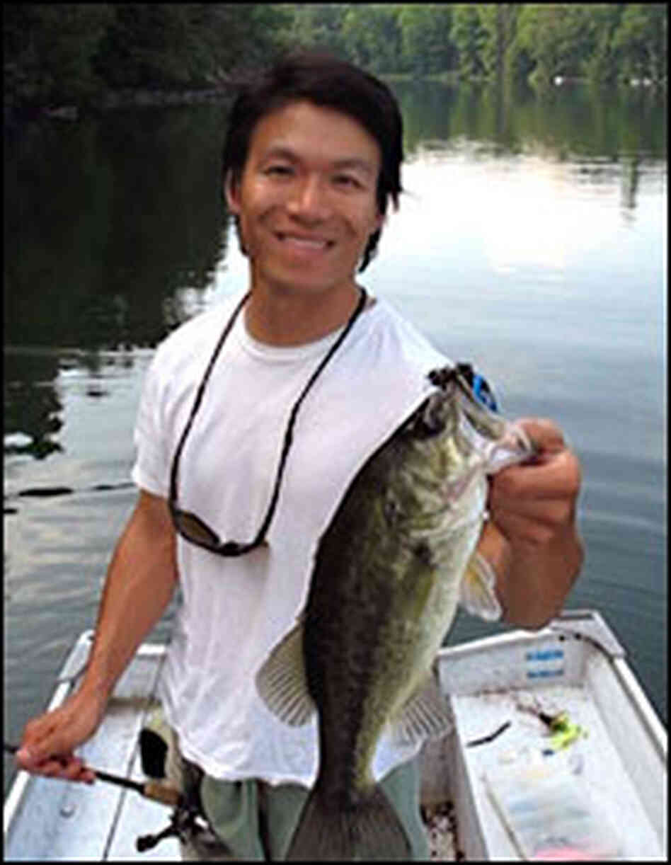 Essayist Jimmy Liao Holds a Fish in a Boat Essayist Jimmy Liao Holds a Fish in a Boat