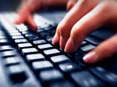 Hands type on a keyboard