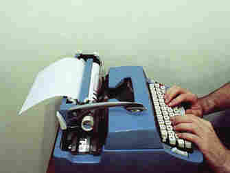 Man types on a typewriter