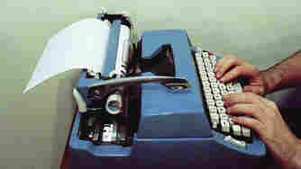 Man types on a typewriter