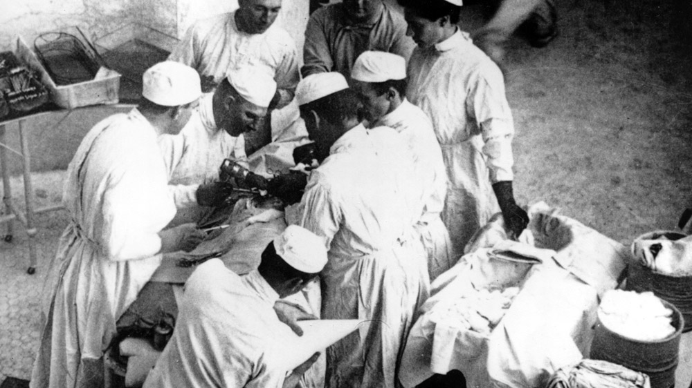 Dr. William Halsted (holding a mallet) operates on a patient at Johns Hopkins in 1904.