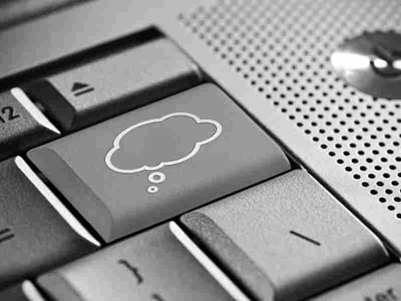 Computer keyboard with a thought bubble on one of the keys.