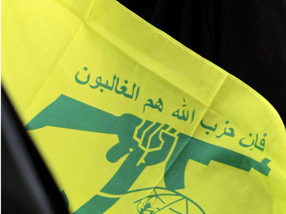 The flag of Hezbollah features a fist holding an AK-47. The gun has become a symbol worldwide, says author C.J. Chivers. (Getty Images)