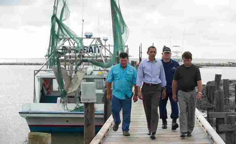 President Obama walks alongside Grand Isle Mayor David Camardelle (from right), U.S. Coast Guard Adm. Thad Allen, who is in charge of the federal response to the spill, and Chris Camardelle after meeting with local business owners in Grand Isle, La., June 4. 