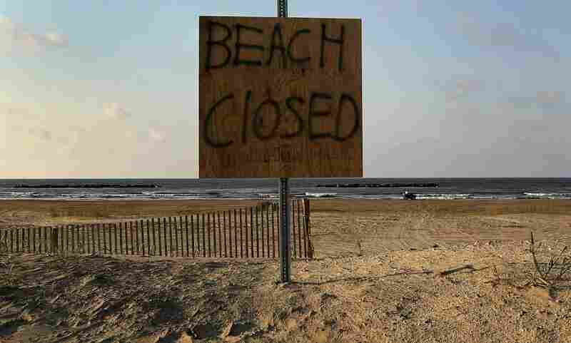 A sign warns the public to stay away from the beach on Grand Isle, La. Officials closed the oil-covered beaches to the public indefinitely on Saturday. 