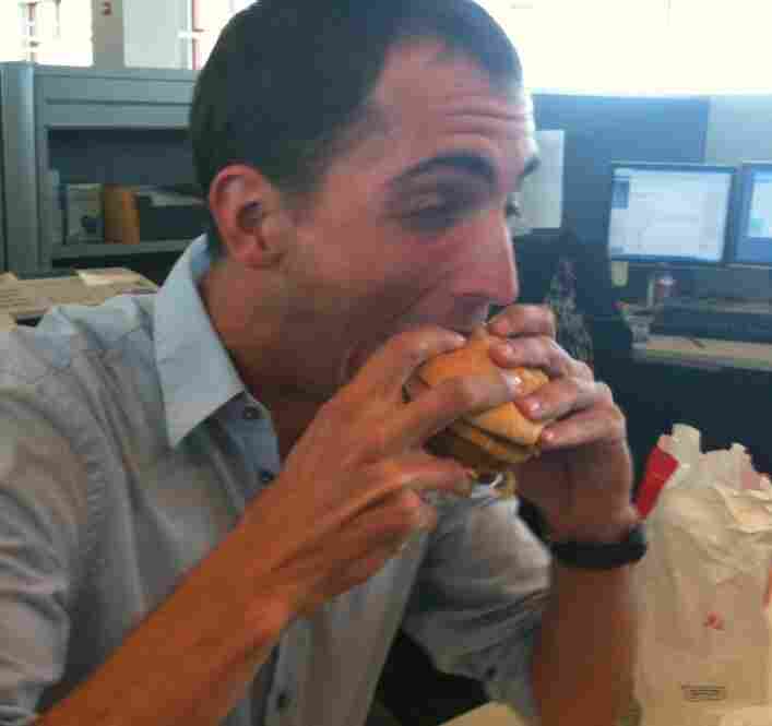 Producer Ian bites a sandwich.