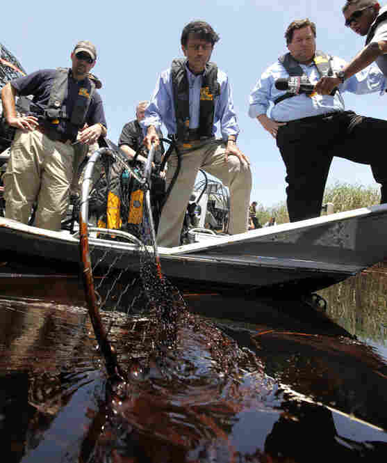 Louisiana Gov. Bobby Jindal (center) and Plaquemines Parish President Billy Nungesser (right) tour the oil-impacted marsh of Pass a Loutre, La. "This is the heavy oil that everyone's been fearing that is here now," said Jindal. 