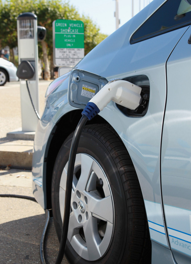 A power cable from a vehicle charging station is seen plugged into the side of a Toyota Prius plug-in hybrid in San Francisco.  (Getty Images)