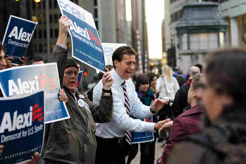 Illinois Democrat Alexi Giannoulias (center) greets commuters after voting in Chicago. Giannoulias lost the race for President Obama's former Senate seat to Republican Rep. Mark Kirk. 