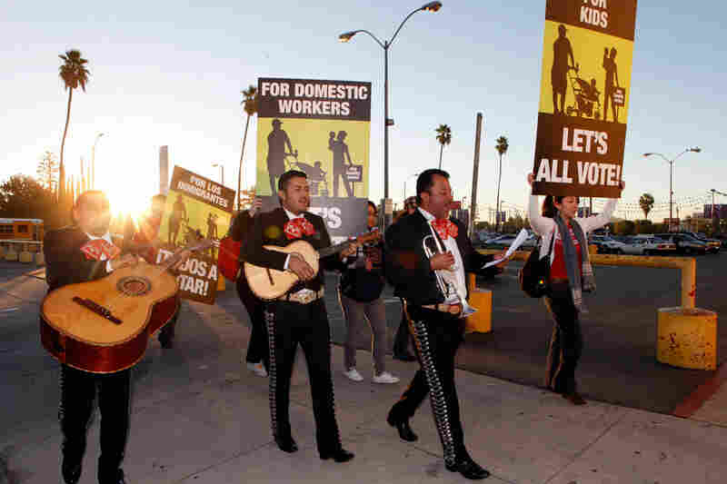 Members of the mariachi band Los Munecos and volunteers with the Coalition for Humane Immigrant Rights of Los Angeles (CHIRLA) serenade voters in North Hollywood. Advocates in Los Angeles urged immigrants to vote early. 