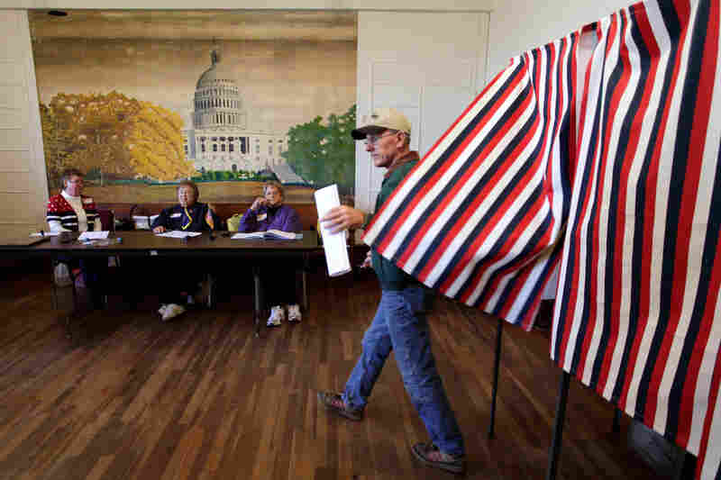 Gary Walburn votes in the general election at the Hayes Township Hall in Ottawa, Kan. 