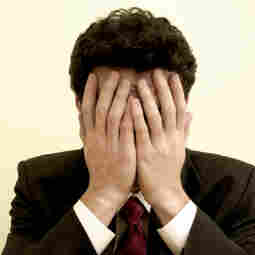 a man with his hands over his eyes