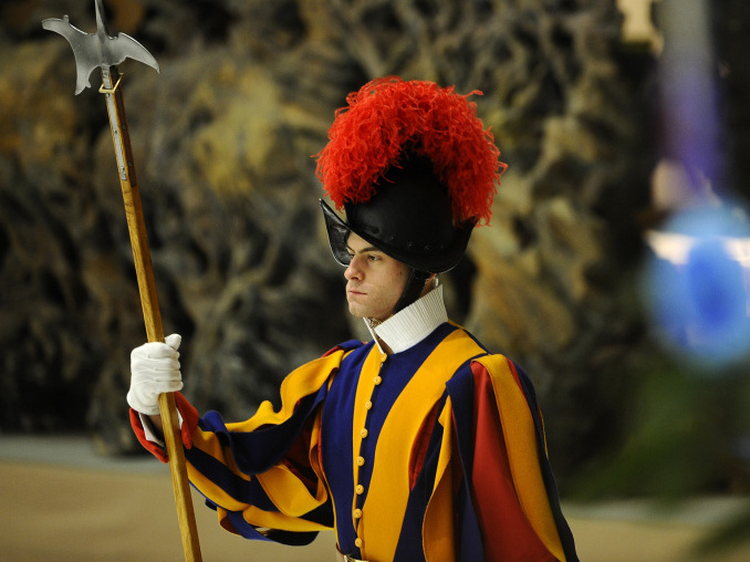 A Swiss Guard stands by a Christmas tree at the Vatican. Members of the Swiss Guard are born in Switzerland, but are not a part of the country's defense forces. (AFP/Getty Images)