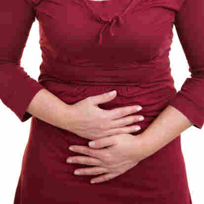 Woman holding her stomach with her hands