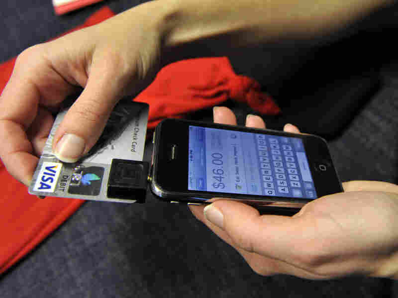 In this Dec. 18, 2009, photo, Willo O'Brien demonstrates Square on her iPhone in San Francisco. O'Brien, a designer and illustrator, uses Square for credit card transactions with her customers. Users can sign for purchases by writing with a finger on the iPhone's touch screen.