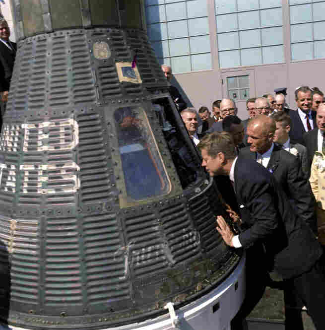 President Kennedy gets a look inside the Mercury capsule that was piloted by John Glenn (at Kennedy's right) on Feb. 23, 1962.  