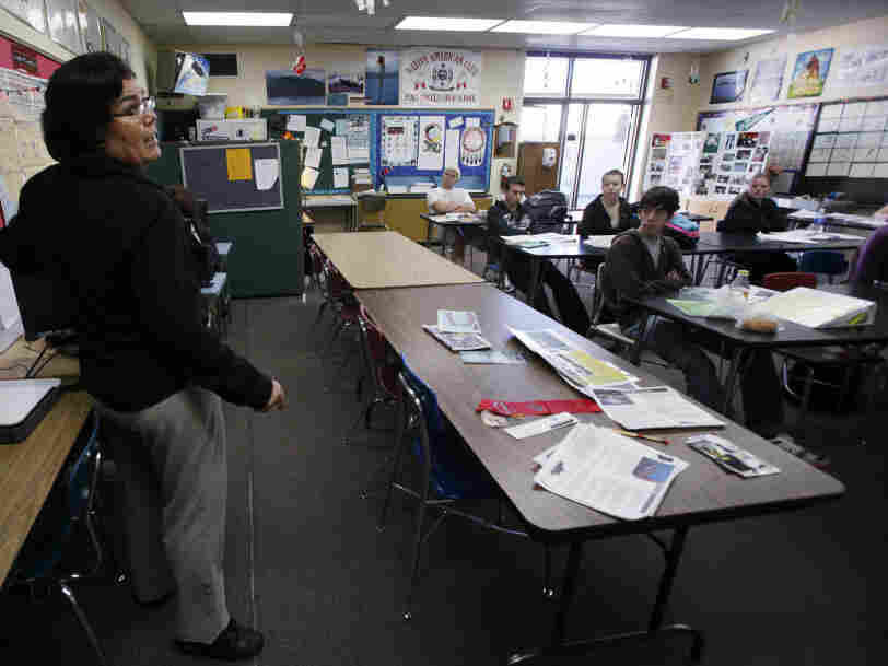 A teacher talks to her students.