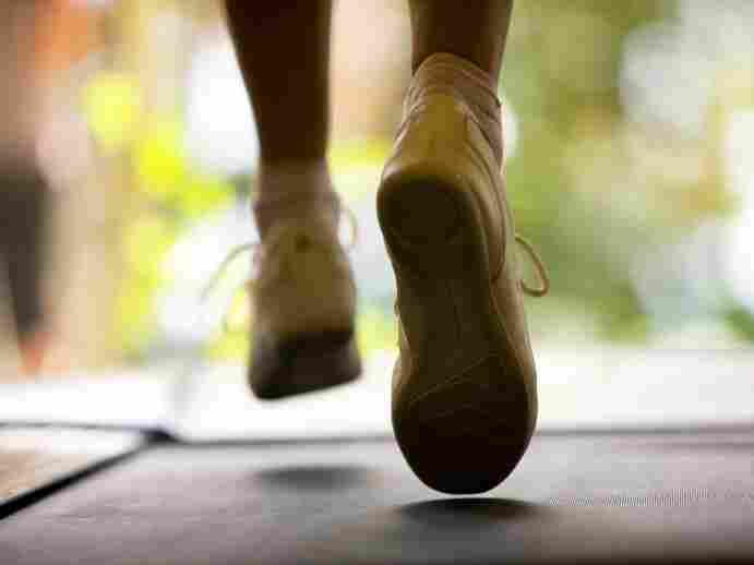 Close up of woman running on treadmill.