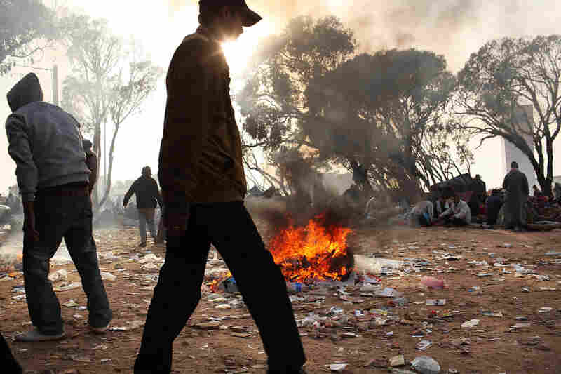 Trash fires burn at a border area in Tunisia on Thursday, where migrant workers from Libya are living in squalid conditions. Tunisia's situation is quickly turning into a humanitarian emergency as the country is overwhelmed with refugees. 