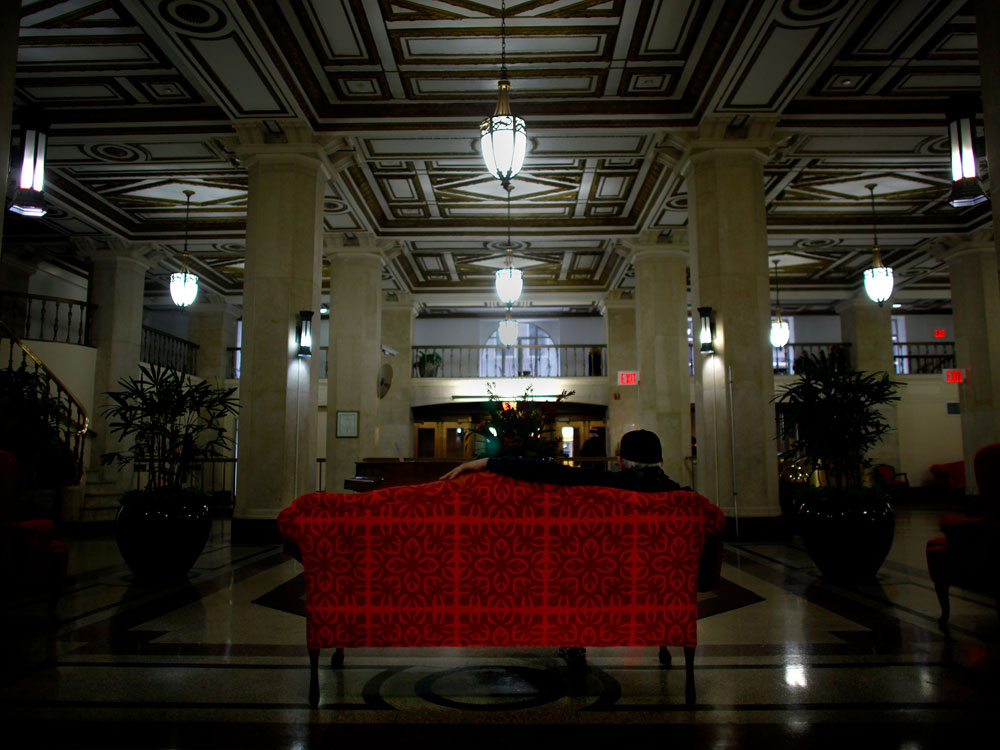 The grand two-story lobby of the Times Square Building boasts marble floors and gold-trimmed ceilings. Common Ground redeveloped the once-dilapidated building into 652 units for low-income and formerly homeless tenants in 1991. (NPR)