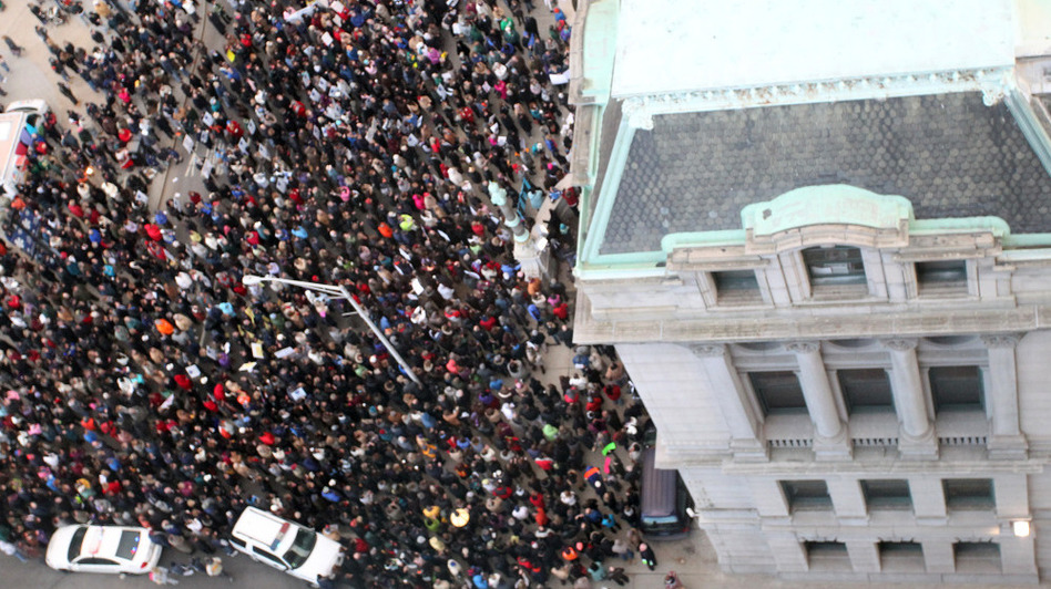 Teachers and union members rally on the steps of Providence, R.I., City Hall on Wednesday to protest the firing of the city's entire teaching force. (Stew Milne/AP)