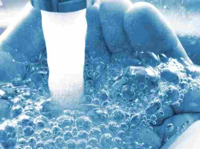 Water bubbles into outstretched hands.