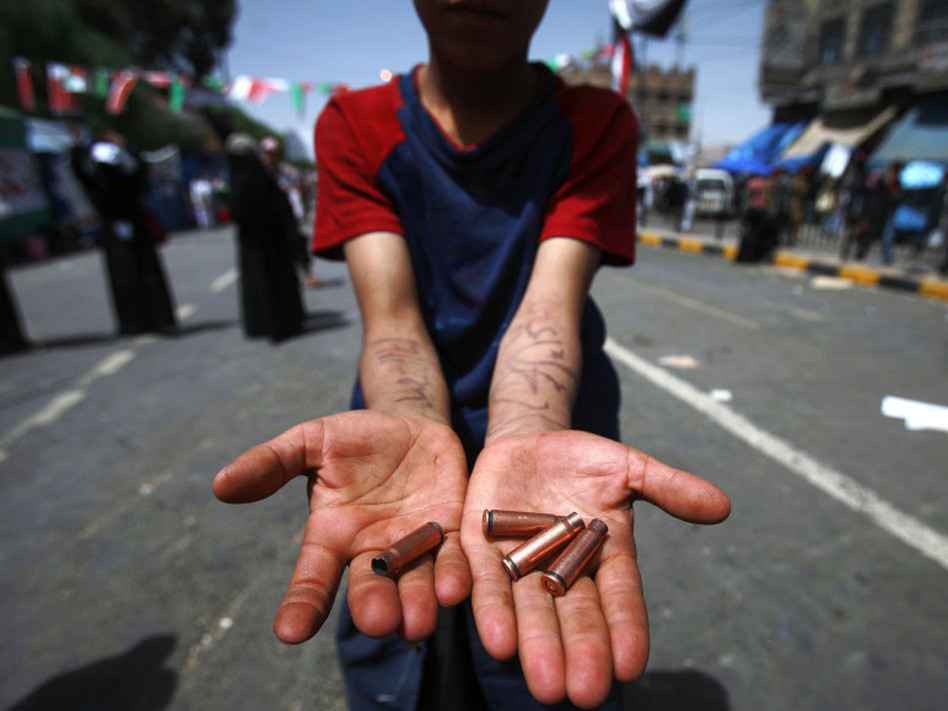 An anti-government protester displays bullet shells during clashes in Sanaa,Yemen, on Tuesday. (Muhammed Muheisen/AP)