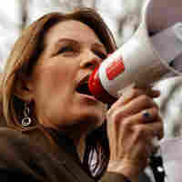 Rep. Michele Bachmann (R-MN), holding a stack of petitions, addresses a "Code Red" rally on Capitol Hill in March 2010, sponsored by The American Grassroots Coalition and the Tea Party Express. The rally was in opposition to the health care overhaul bill. Rep. Michele Bachmann (R-MN), holding a stack of petitions, addresses a "Code Red" rally on Capitol Hill in March 2010, sponsored by The American Grassroots Coalition and the Tea Party Express. The rally was in opposition to the health care overhaul bill.