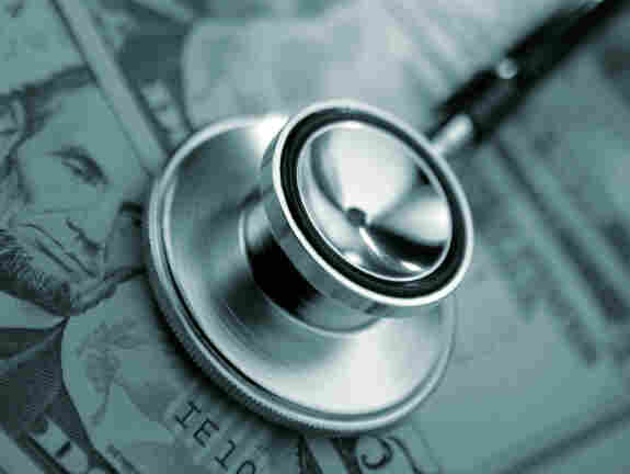 Stethoscope on some crisp $5 bills.
