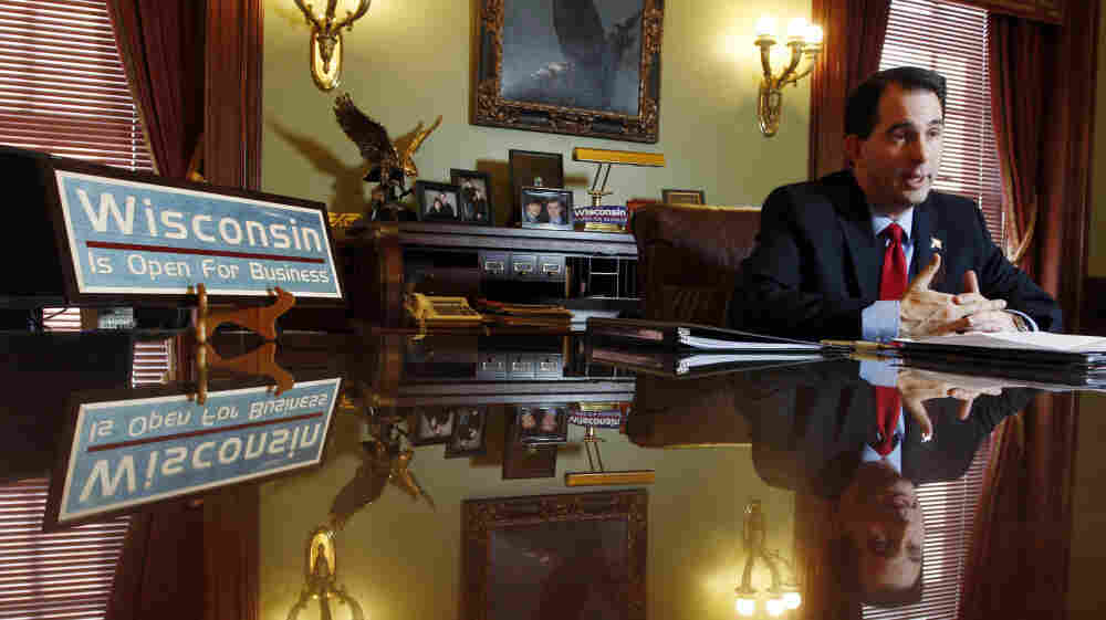 Scott Walker, with sign.
