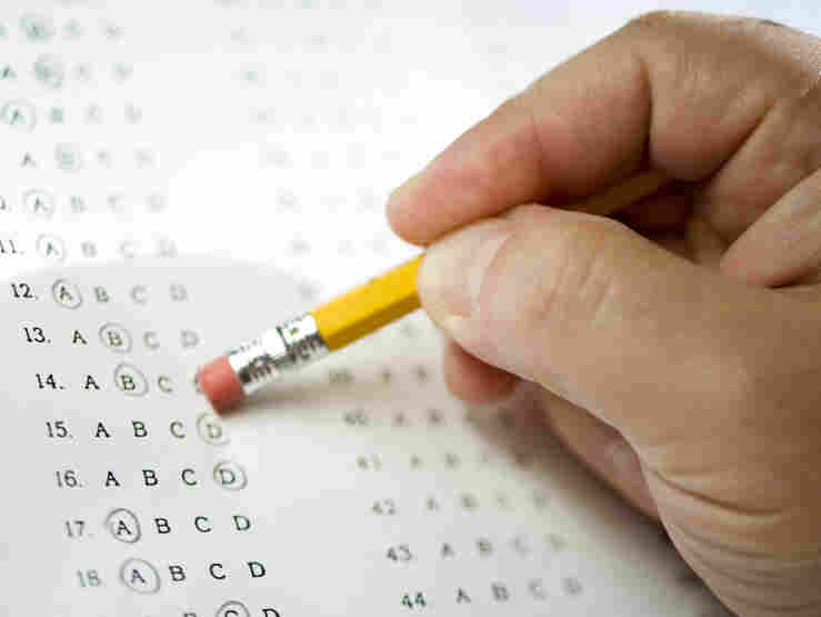 Man erases answer to a test question.