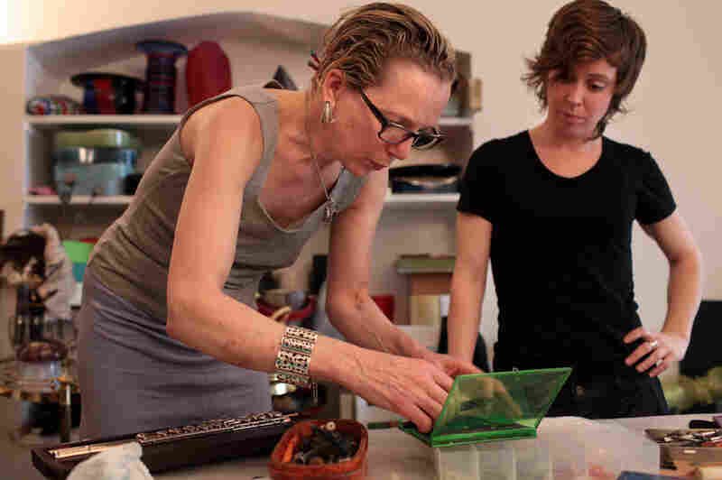 Anne Pollock, New York's go-to person for flute repairs, makes adjustments to the gold head joint of Chase's instrument while she looks on.