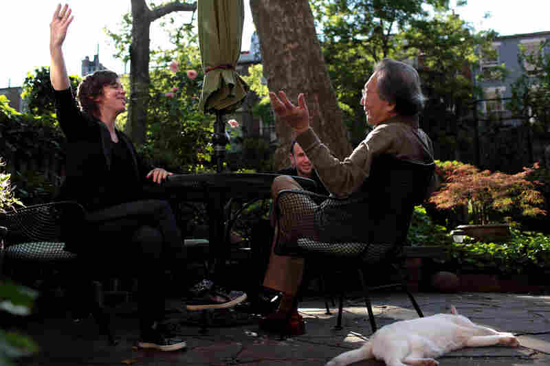 In the garden behind the house, Chase, Rubin and Chou discuss an upcoming performance of Varese's works by ICE.