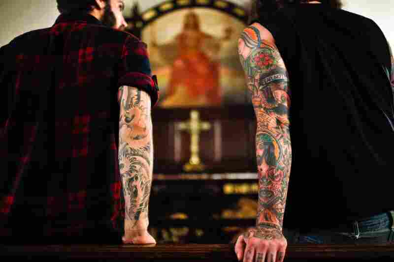 Lee Burford (right), drummer for The Body, and Zac Jones, drummer for Braveyoung, look at a painting in the St. Stephen's sanctuary.