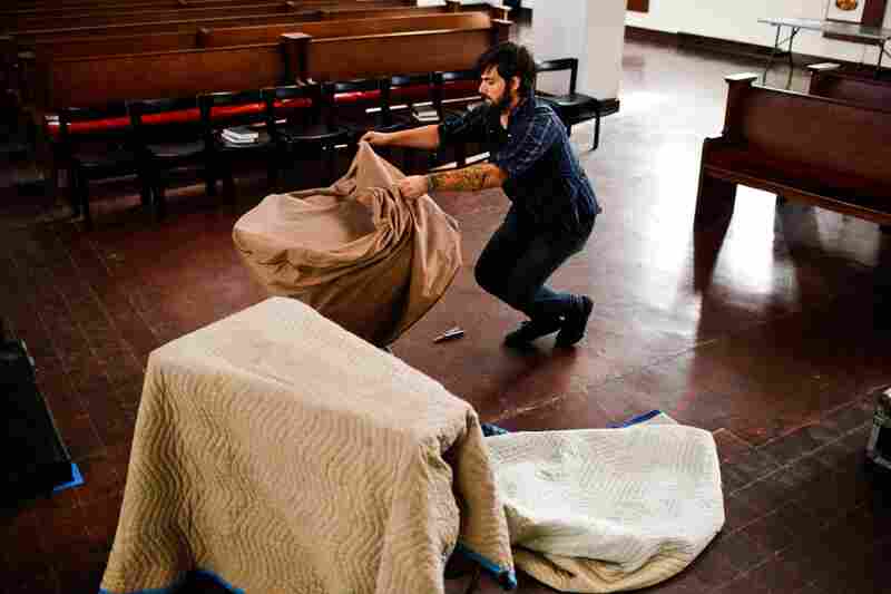 Isaac Jones, guitarist for Braveyoung, unpacks a tympani before the band's performance.