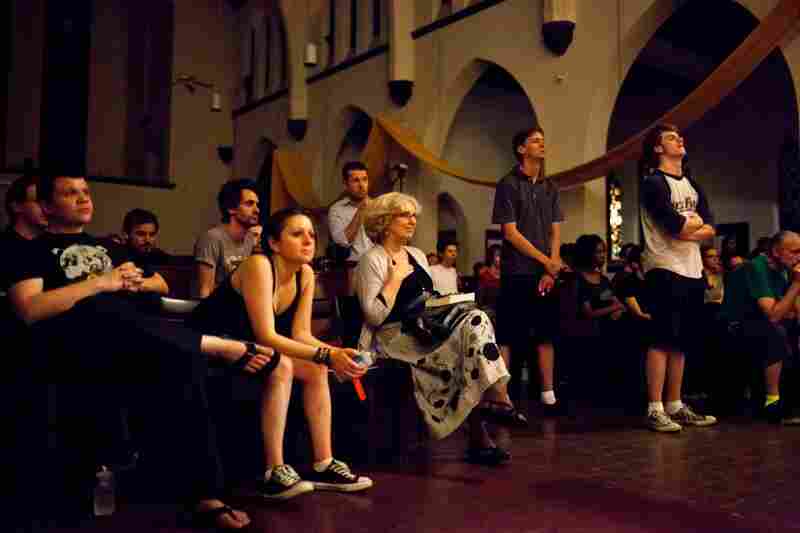 Jenufa Kent (center, hand on chest) of Vienna, Va., watches her daughter, Natalja, perform with the choir.