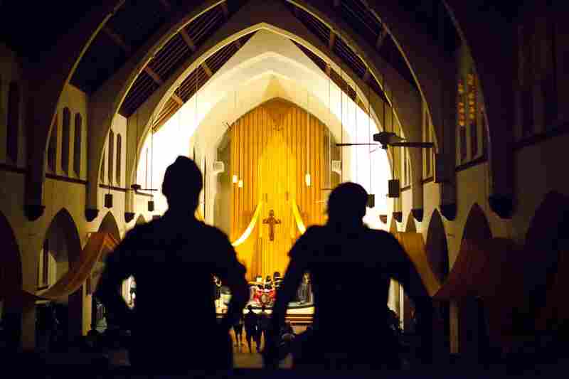 Attendees watch the choir from the balcony.