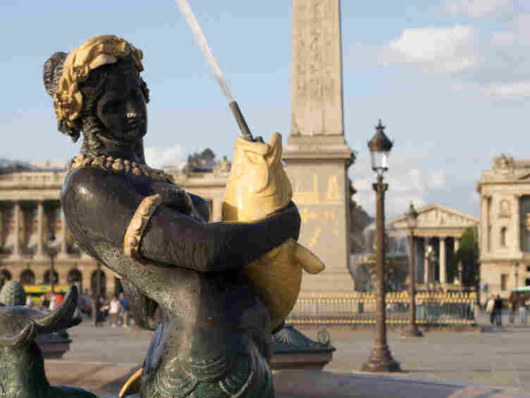 Mermaid sculpture in a fountain at Place de la Concorde in Paris.