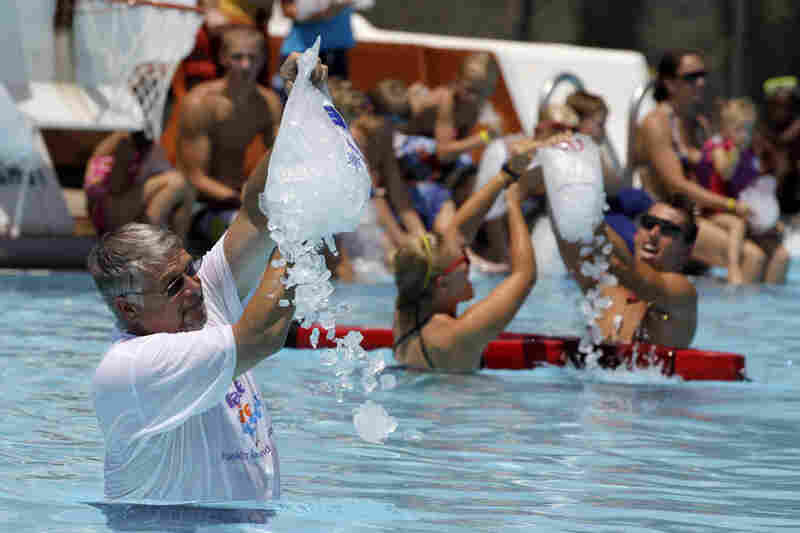 Franklin, Ind., Mayor Fred Paris pours one of 250 bags of ice into the Franklin Memorial Swimming Pool on Thursday. 