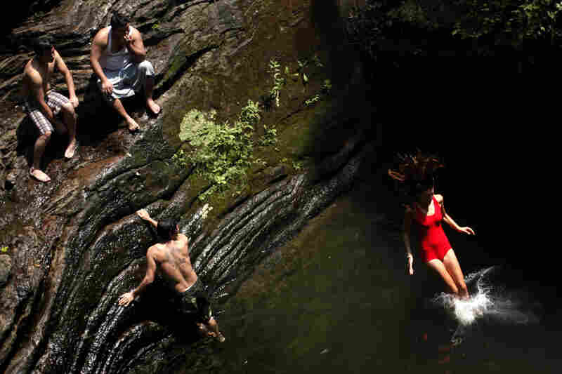 Bathers beat the midday heat at the Devil's Pool in Wissahickon Valley Park on Wednesday in Philadelphia. 